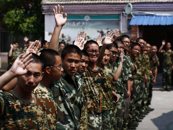 His classmates wave goodbye as he leaves.