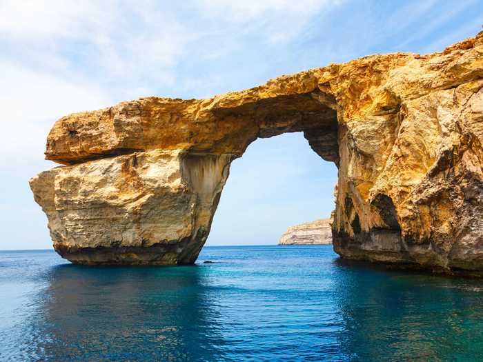 Snap a photo at the Azure Window, a natural Limestone arch on the Maltese island of Gozo.