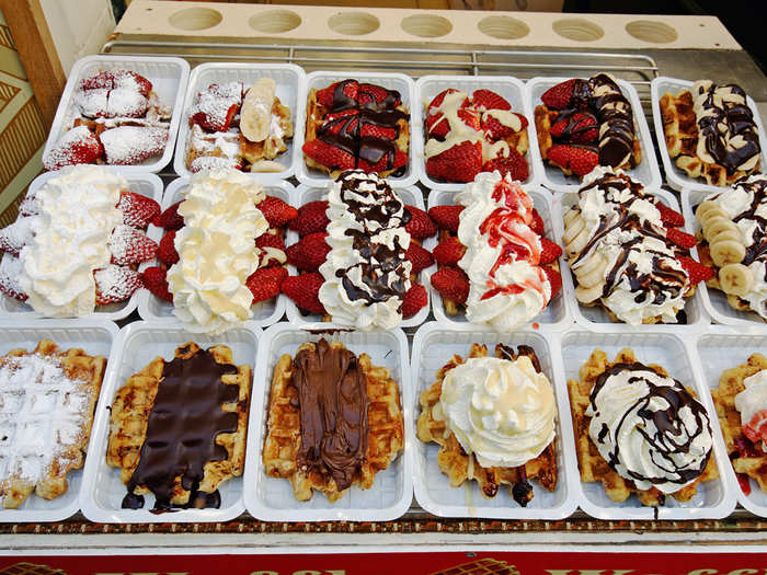 Indulge with fresh gaufres chaudes (hot waffles) topped with strawberries, whipped cream, Nutella, and more in Belgium.