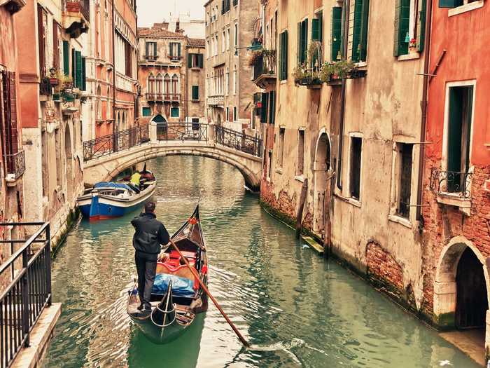 Take a gondola ride through the winding canals of Venice, Italy.