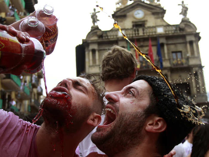 Sangria is the drink of choice for party-goers, whose traditional white shirts quickly become soaked to a pink color as they sing, dance, and celebrate.