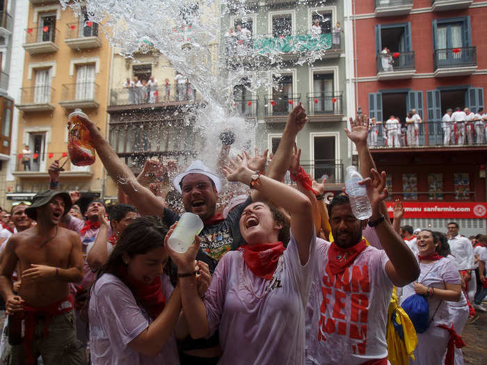 Adding to the ruckus, tenants in the apartments above the square throw large buckets of water on the revelers. No one seems to mind.