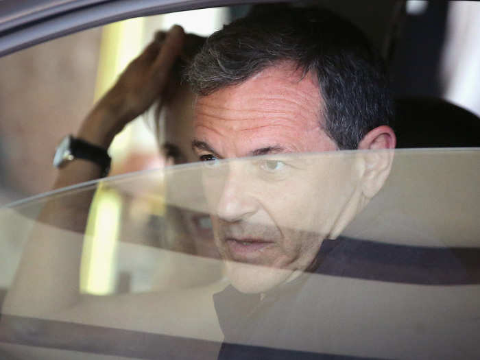 The CEO of Disney, Robert Iger, peers out his car window.