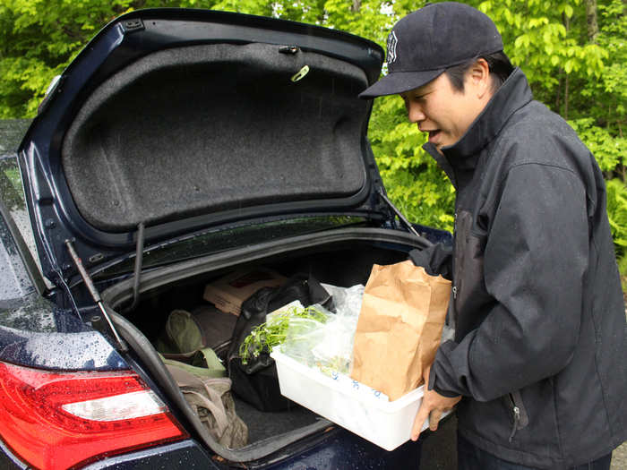 A very gleeful Kida loads his bounty — garlic mustard, garlic scapes, ramps, ginger root, angelica, daisies, and of course, morels — into the rental car.