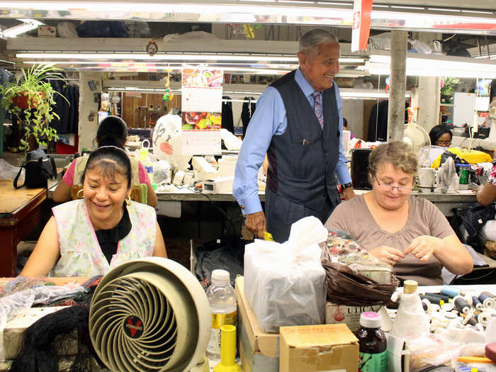 At age 86, he comes to work six days a week and has his hands on every garment — examining, pressing, and expediting it between stations. “I love the work,” Martin says. “I lost my family, but now I have this family.”