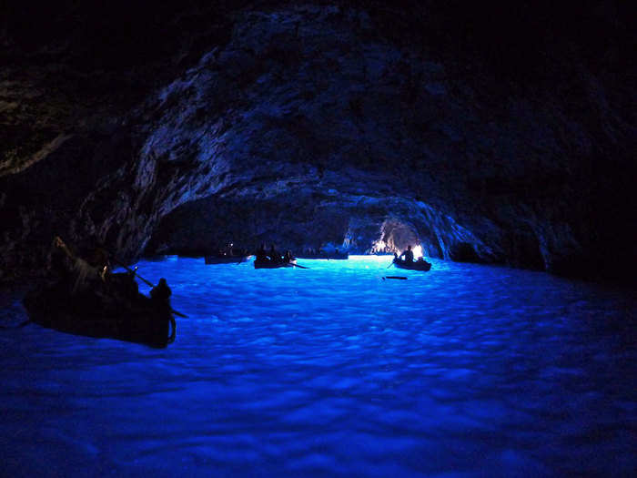 Float through the Blue Grotto, a sea cave in Capri with stunning blue light reflected off of the water.