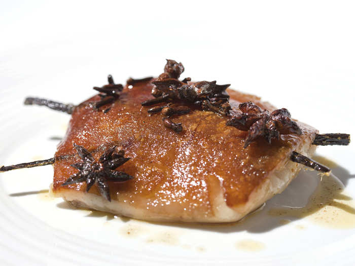 A slow-cooked jowl of pork, reduced and dusted in chicory, arrives at the table in its pre-portioned state. The licorice and spices are removed when served, and replaced with a carrot puree.