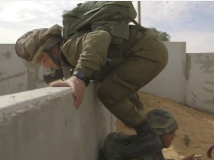 Instead of using the roads to go from place to place, the soldiers climb over each others shoulders and scale walls, so as to remain minimally visible to the enemy.