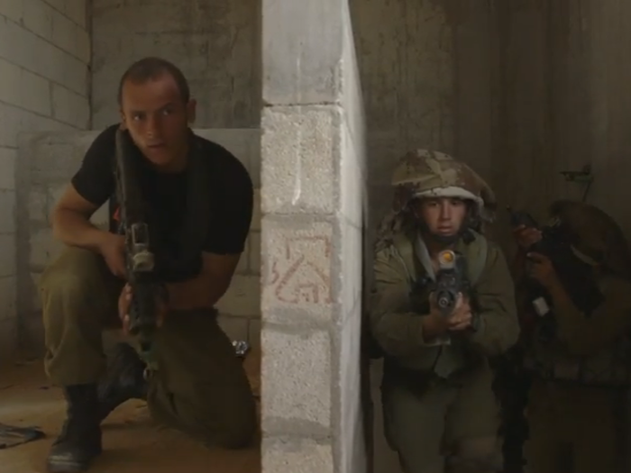 As the soldiers enter a building, there is an enemy militant hiding at the top of the stairs. Sometimes, an enemy is separated by less than a meter.