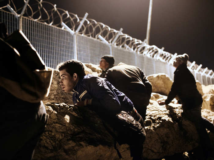 The living situation is particularly bad in Greece. Migrants who land there often attempt to board boats to Italy or trucks into other European countries. Here, a group of migrants in Corinth, Greece wait for the right moment to illegally board a ship.