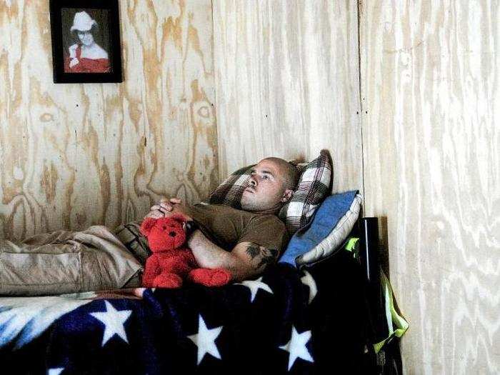 While most photos of war are of fighting, the majority of time is spent waiting around. This helicopter medic waits for a call from a radio channel dedicated to casualty reports. His girlfriend gave him the teddy bear.