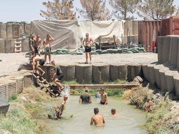 Moments of leisure are prized. Marines swim in an irrigation canal at their outpost in Helmand Province, Afghanistan. The same day, a patrol from another base was hit by an IED.