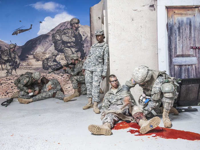 This is a combat life-saving course. Soldiers mimic serious injuries while recruits attempt to bandage them and get them out of the kill zone.