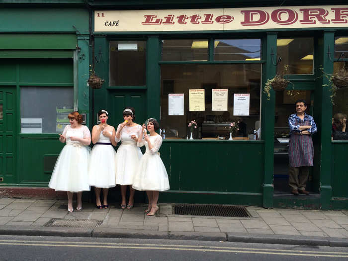 MERIT PRIZE: While exploring Burrough Market in London, this photographer caught these four women dressed in vintage white dresses eating ice cream in front of a shop.