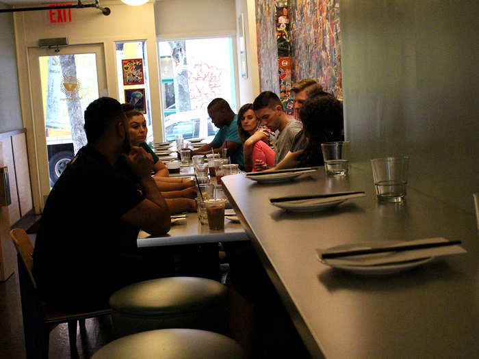 After lunch, the manager wrangles the staff at the front of the restaurant to discuss things like vacation time. But something over by the bar captures their attention ...