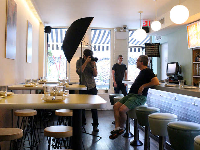 The New York Times photographer has arrived. While the bar area is vacated, Chef Ivan poses for a portrait as the staff watches on, smiling.