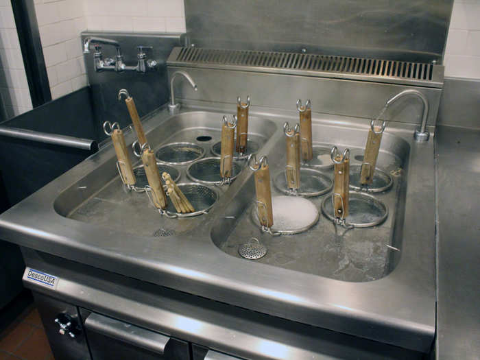 Each order of ramen cooks in a little net, seated in 210-degree water. Two faucets at the back pour a steady stream of cold water in, to keep the water from evaporating.