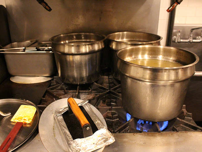 Different varieties of broth are transported to these pots in the assembly area.