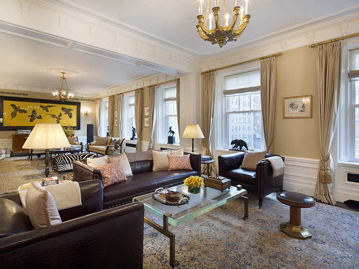 The living room holds zebra-print furniture, animal statues, and a large portrait of flying birds.