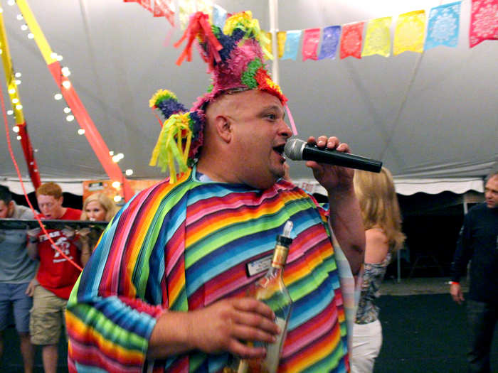 We freshen up and head to the big tent, where the 300 other guests seem to have wasted no time waiting for us. Bluto, director of entertainment and the man of a million costumes, oversees a group taking tequila shots off a surfboard.