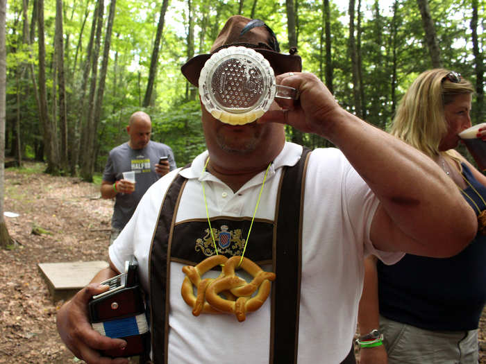 At 2:30, Bluto, dressed in lederhosen, wrangles the troops for the Pub Hike. We thread pretzels onto yarn necklaces, fork over 10 beer tokens, and follow the sound of the boom box into the woods.