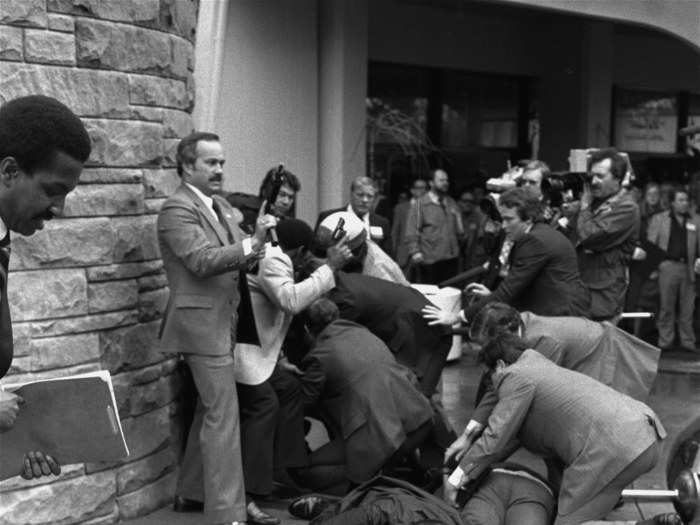 This photo, taken by Ron Edmonds in 1981, shows Secret Service agent Timothy J. McCarthy, foreground, Washington policeman, Thomas K. Delehanty, center, and presidential press secretary James Brady, background, laying wounded on a street outside a Washington hotel after shots were fired by John Hinckley, Jr., who pushed a pistol through a cluster of bystanders and fired six shots at President Ronald Reagan. Brady, who was permanently disabled due to the attack and later became a gun control advocate, passed away earlier this month at the age of 73.