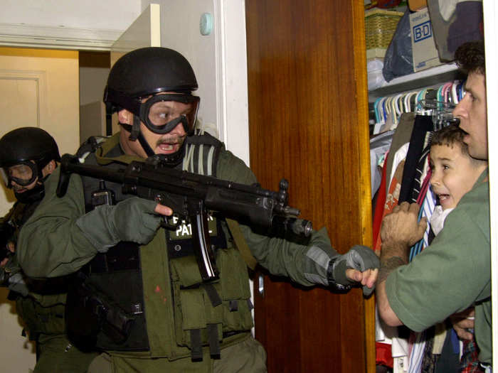 In this third of seven sequential photos that won Alan Diaz the Prize in 2001, Elian Gonzalez is discovered in a closet as government officials search the Miami home of Lazaro Gonzalez, Elian’s great-uncle, for the young boy in 2000. The 6-year-old Elian had recently defected from Cuba to the US where his extended relatives were petitioning for his asylum against the wishes of his Cuban father, creating a large controversy between Cuba and the US over custody and immigration rights.