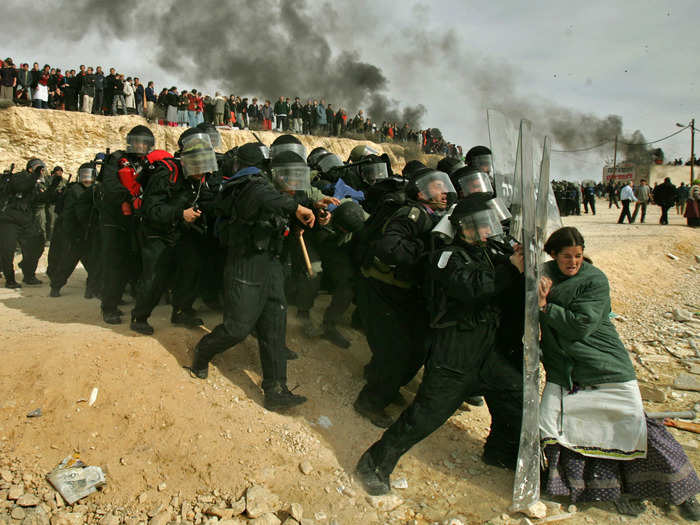 A lone Jewish settler struggles with an Israeli security officer during clashes that erupted as authorities evacuated the West Bank settlement outpost of Amona, east of the Palestinian town of Ramallah, in early 2006. This photo, taken by Oded Balilty, won a 2007 Pulitzer Prize.