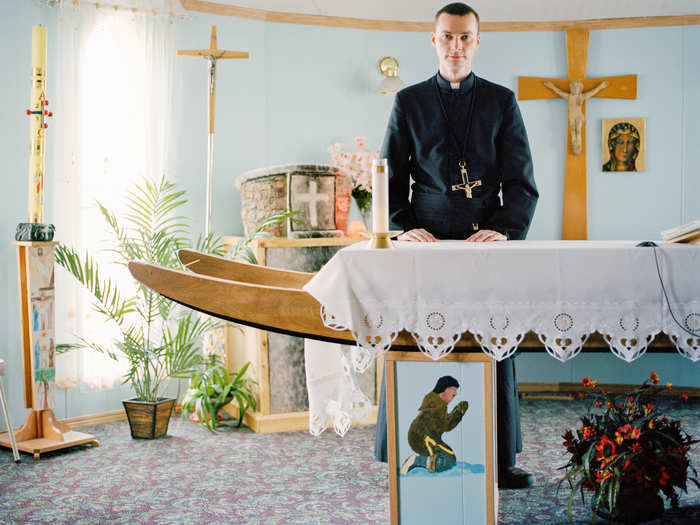 Daniel Szwarc is a Polish missionary priest at the Roman Catholic Mission in Repulse Bay, Canada. Here, he is seen standing at an alter made from an Inuit sledge.