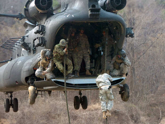 ... Special Forces fast-roping onto land ...