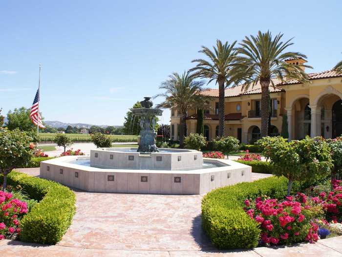 The property is surrounded by 63 acres of Cabernet Sauvignon vines. The front of the home is marked by a large fountain.