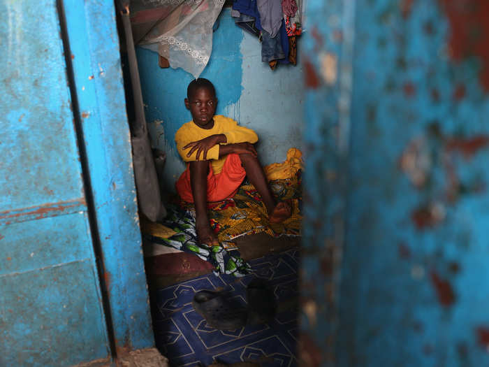 People suspected of contracting Ebola are being brought to buildings converted to be Ebola isolation wards. Here, Andrew, 14, is about to be taken to an isolation ward.