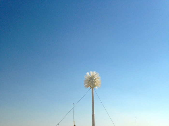 Like this toilet brush cleaner statue, located conveniently near a line of porta potties.