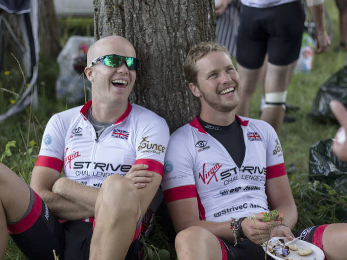Sam Branson and cousin Noah Devereux laugh during a much-needed break from cycling.