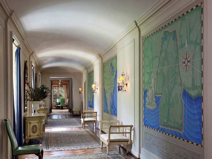 The barrel vaulted central gallery, which connects the lower level to the upper bedroom wings, is lined with hand-painted period murals.