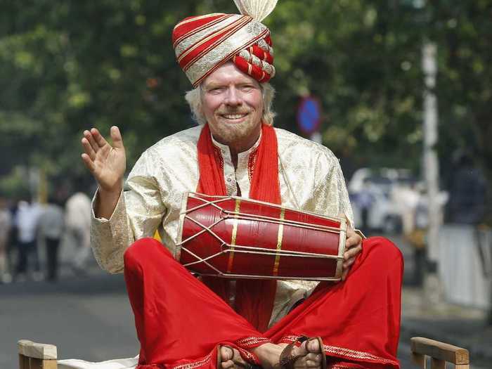 For a promotional event in Mumbai, Branson rode atop a taxi dressed as a traditional Indian musician.