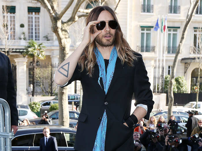 Jared Leto is the King of Cool wearing a light blue scarf under his suit and aviators at a Miu Miu fashion show.