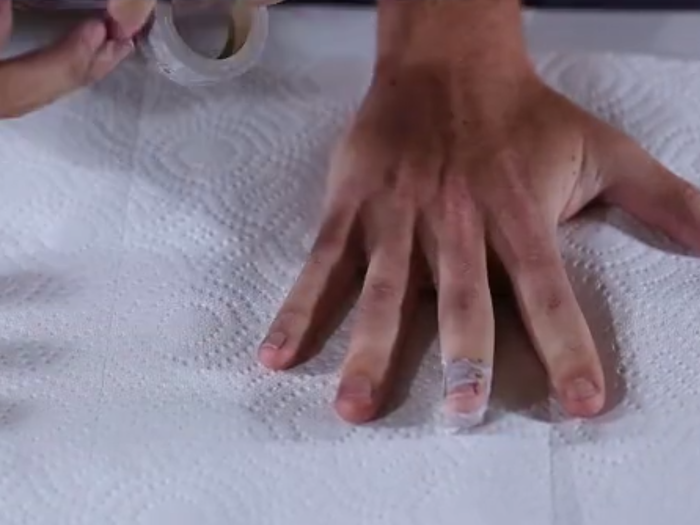 Now prep your hands to be printed on. Tape around the nails to prevent staining on skin.