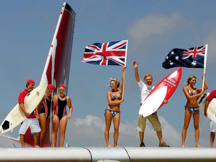 Branson always brings an element of fun to Virgin Atlantic flights. Here, he poses with models and lifeguards on the wing of a plane that had just landed in Sydney.