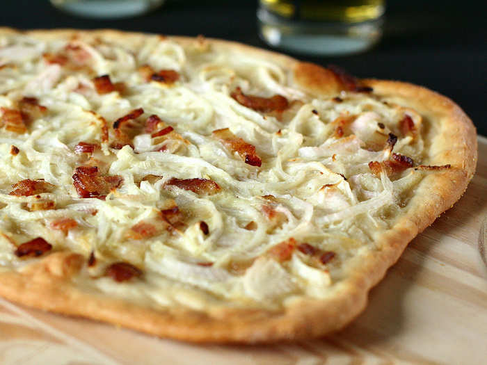 Try a tarte flambée (a type of flatbread pizza usually topped with cheese, ham, and onions) in Alsace.