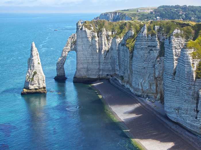 See the chalk cliffs of Étretat, in Normandy.