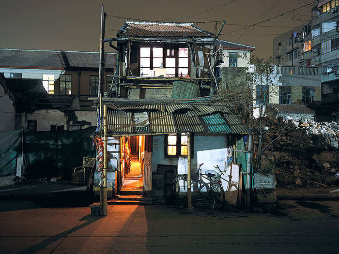 In buildings where families refused to leave, demolition and construction often continued around the property, leaving behind a "nail house," a Chinese term referring to a lone house amidst a construction zone.