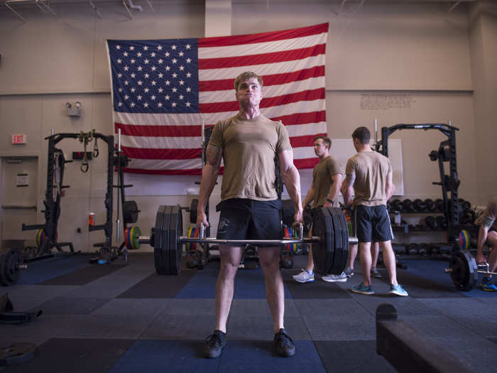 A member of the Air Force Special Operations Command’s Special Tactics Training Squadron strains while lifting weights during a strength and conditioning session at Hurlburt Field, Fla.