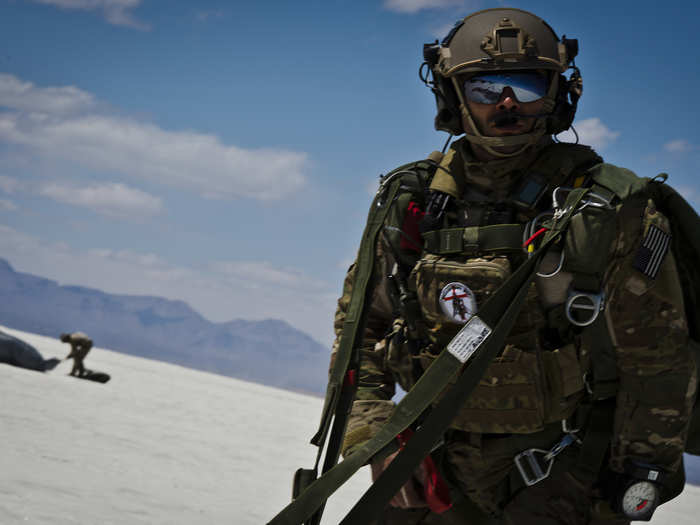 Staff Segeant Welby Ramos, a combat controller with the 22nd Special Tactics Squadron out of Joint Base Lewis-McChord, Wash., watches as other members of his team land after parachuting 13,000 feet for training.