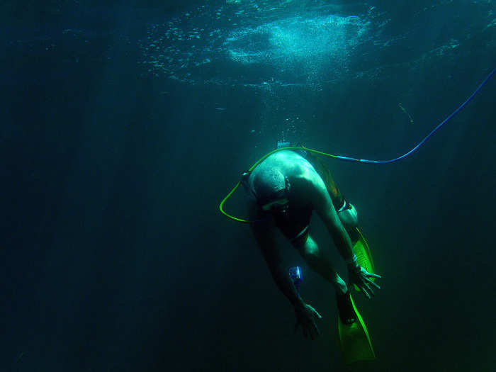 Paul Kuntne tries to dive down as he uses a snuba system off the coast of Roatan, Honduras on December 25, 2012. Snuba is an underwater breathing system in which air comes through a long hose from tanks on pontoon rafts on the surface of the water.