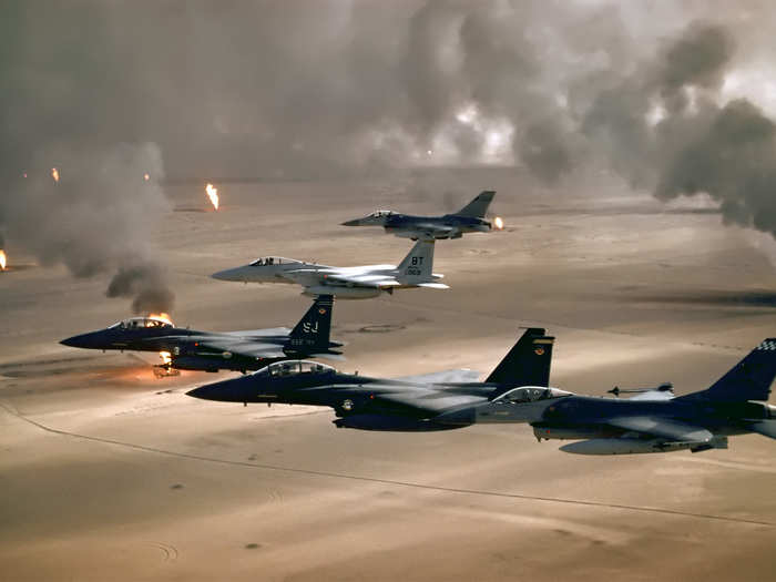 USAF aircraft of the 4th Fighter Wing (F-16, F-15C and F-15E) fly over Kuwaiti oil fires, set by the retreating Iraqi army during Operation Desert Storm in 1991.