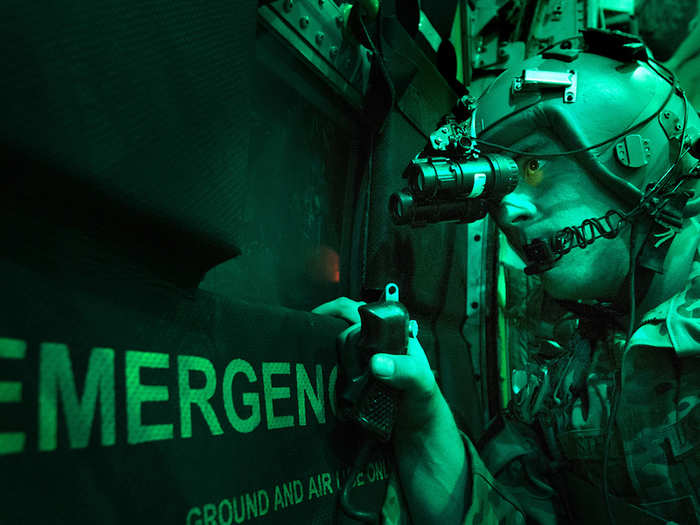 Senior Airman Larry Webster scans for potential threats using night vision goggles after completing a cargo airdrop in Ghazni Province, Afghanistan. Webster is a loadmaster assigned to the 774th Expeditionary Airlift Squadron at Bagram Air Base, Afghanistan.