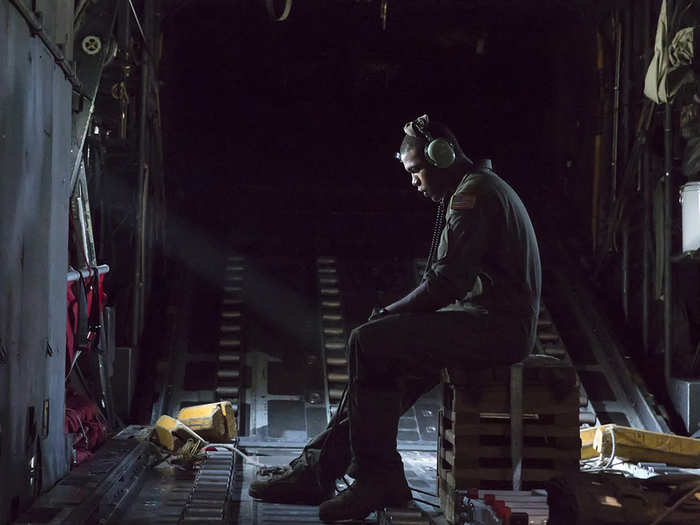 Airman 1st Class Wynthom Thomas communicates with pilots after their landing at Yokota Air Base, Japan. Seven C-130 Hercules flew in formation practicing airlift tactics and procedures.