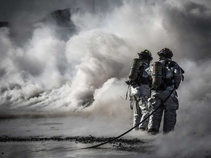 Firefighters from the 366th Civil Engineer Squadron extinguish a fire during a training exercise at Mountain Home Air Force Base, Idaho. Two teams worked in unison to push the fire back without it reigniting behind them. The training exercise was one component of a base-wide operational readiness exercise.