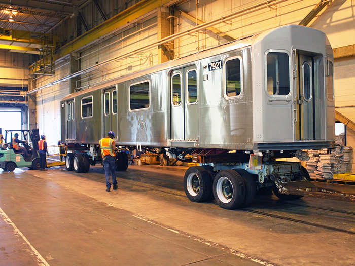 The main bodies of the subway cars, known as "shells," arrive at the Yonkers plant on large flatbed trucks from Kawasaki